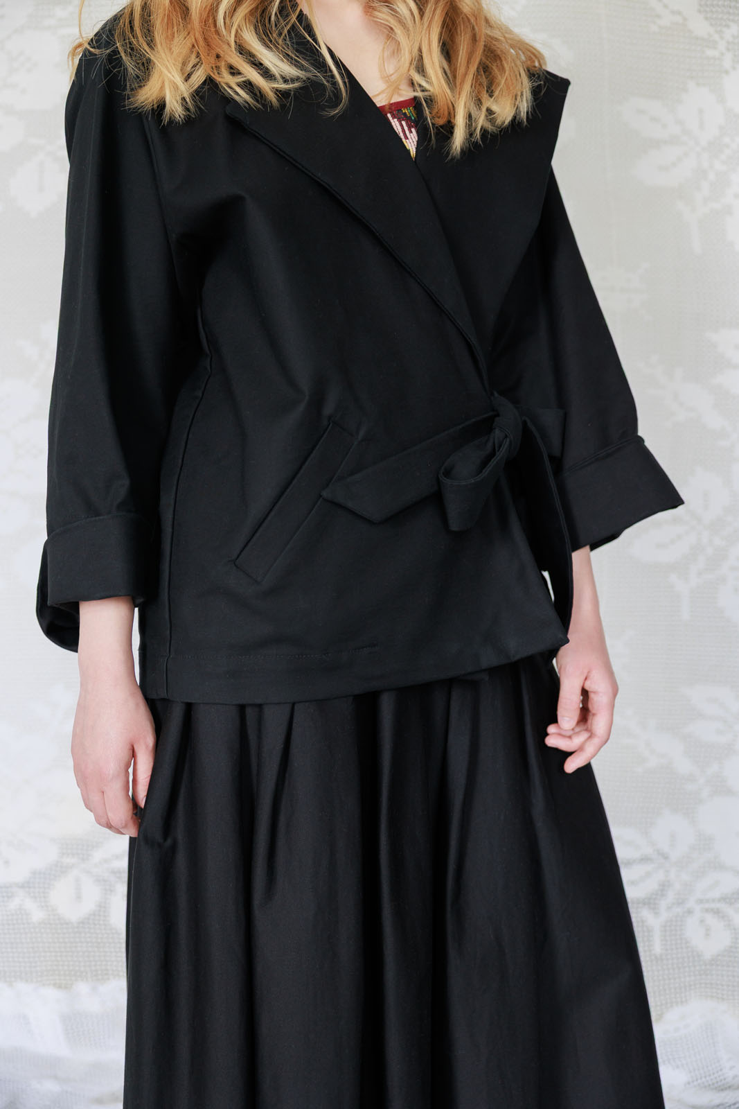Kurtka kimono z grubej bawełny z szerokimi, regulowanymi rękawami, zbliżenie na detal.